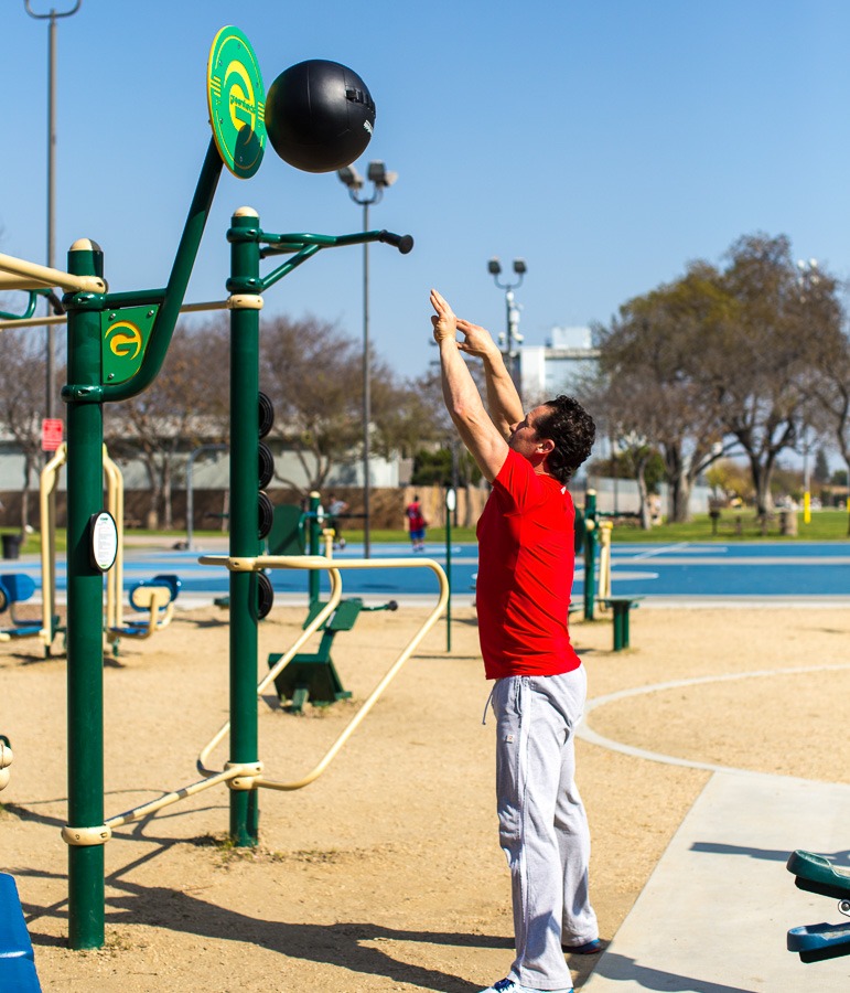 A man doing wall ball with the ball target.