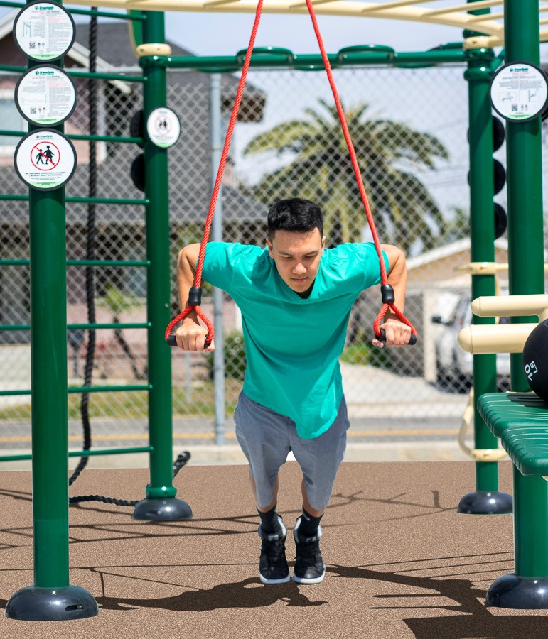 A man exercising with suspension trainers