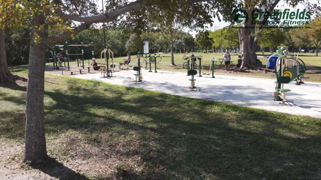 An outdoor gym with trees in the background.