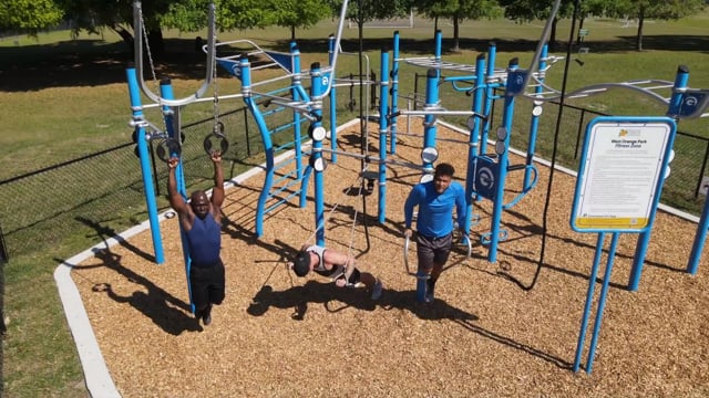 Three men exercising on a blue Custom Functional Fitness Rig at West Orange Park